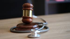 gavel and stethoscope on table