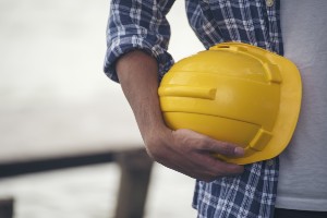 Construction worker holding hard hat